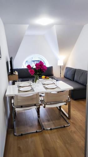 a living room with a table and a couch at Apartamenty INTERDOM in Zakopane