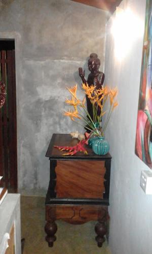 a table with a vase of flowers on top of it at Secret Bay Hotel in Delgalla