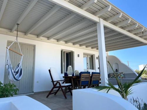 a patio with awning and a table and chairs at Villa Tranquilita in Kastraki Naxou