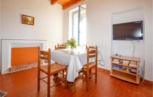 une salle à manger avec une table, des chaises et une télévision dans l'établissement Awesome Home In Coti-Chiavari, à Coti-Chiavari