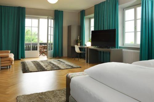 a bedroom with green curtains and a bed and a desk at Jaglhof in Gamlitz