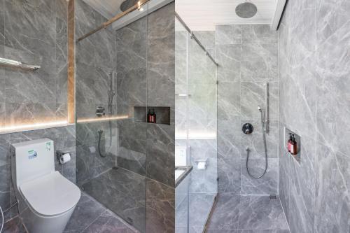 a bathroom with a shower with a toilet and a sink at The Lai Tiny House - Villa at Mae Kampong in Chiang Mai