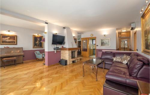 a living room with a couch and a fireplace at Pet Friendly Home In Krk in Krk