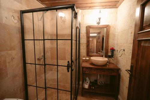 a bathroom with a shower and a sink at Cappadocia Old Houses in Nevsehir