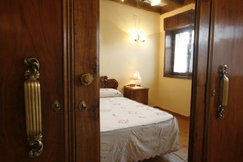 a small bedroom with a bed and a window at Casa Felisa Pirineo Aragonés in Santa Eulalia de Gállego