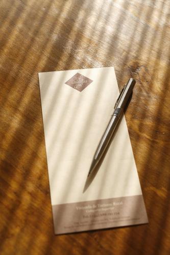 a pen sitting on top of a piece of paper at Casa Felisa Pirineo Aragonés in Santa Eulalia de Gállego