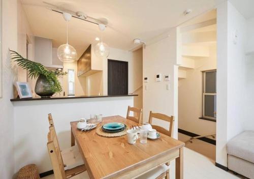 a kitchen and dining room with a wooden table and chairs at Naka HOUSE in Tokyo