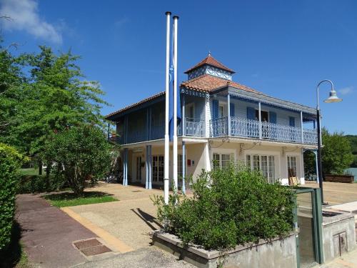 an old building with a tower on top of it at Le nid du lac in Marciac
