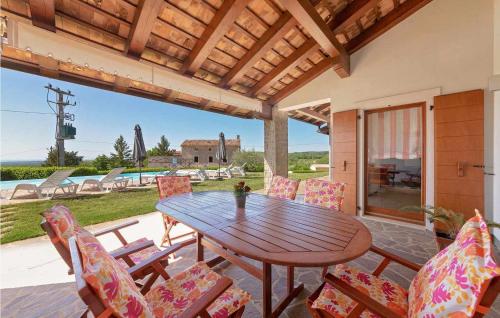 a wooden table and chairs on a patio at Villa Ciano in Višnjan