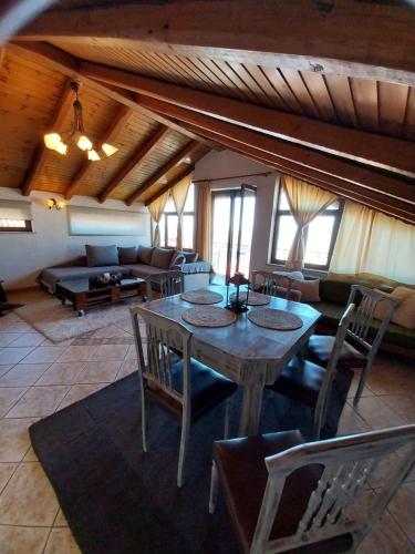 a living room with a table and chairs and a couch at Gianna's Guest House in Arachova