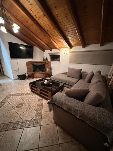 a living room with a couch and a table at Gianna's Guest House in Arachova
