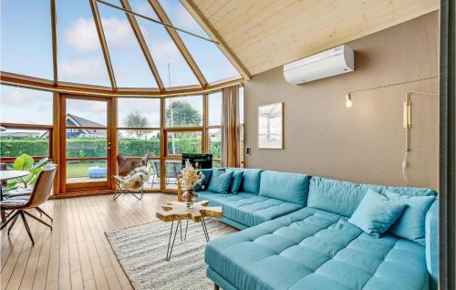 a blue couch in a living room with a large window at Two-Bedroom Holiday Home In Hejls in Hejls