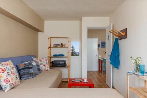 a living room with a couch and a table at STAY Rhodes HoStel & Bar in Rhodes Town