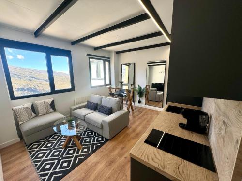 a living room with a couch and a table at Triplex Loft Mountain ZONA BAJA in Sierra Nevada