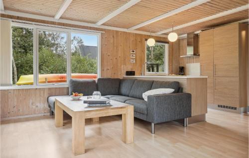 a living room with a couch and a table at Nice Home In Thyholm With Wifi in Thyholm