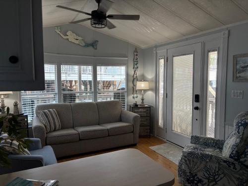 a living room with a couch and a ceiling fan at Seaside Therapy in Myrtle Beach