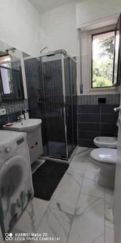a bathroom with a shower and a toilet and a sink at Villa Eufemia in Pedara