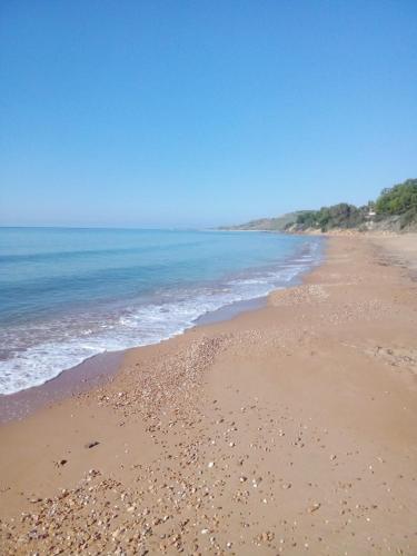 a beach with a lot of rocks in the water at residence timpirussi in Sciacca