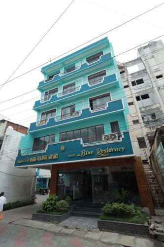 a blue building with a blue restaurant sign on it at Hotel Blue Residency in Nāgercoil