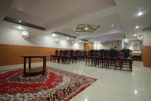 a conference room with chairs and a table and a rug at Hotel Blue Residency in Nāgercoil