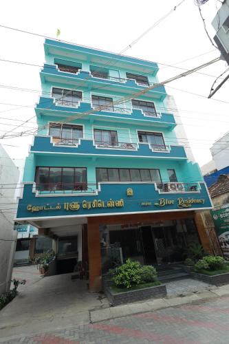a blue building with a sign in front of it at Hotel Blue Residency in Nāgercoil