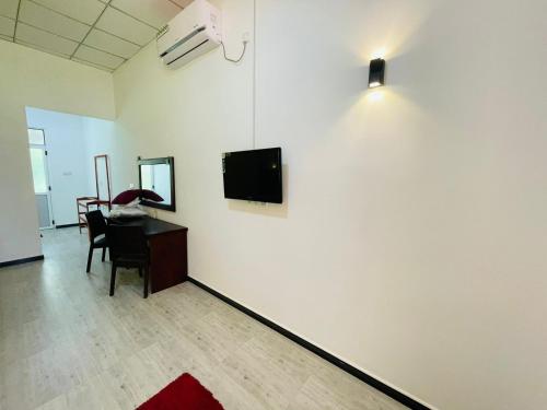 a room with a desk and a tv on a wall at Water Bird's Resort & Yala Safari in Tissamaharama