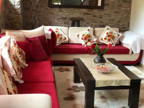 a living room with a couch and a coffee table at Restauraunt-Kalaja in (( Bokaj ))