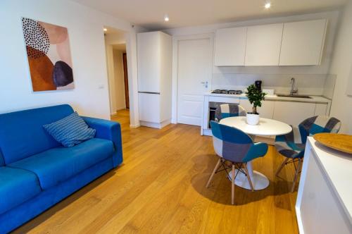 a living room with a blue couch and a table at Attico 58 in Foggia