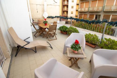 a balcony with chairs and a table on a balcony at Attico 58 in Foggia