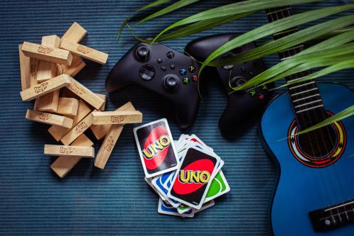 a video game controller and chips next to a guitar at Delight ART Villas in Seminyak