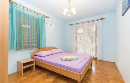 a bedroom with a purple bed and a window at Beautiful Apartment In Povile With Wifi in Povile