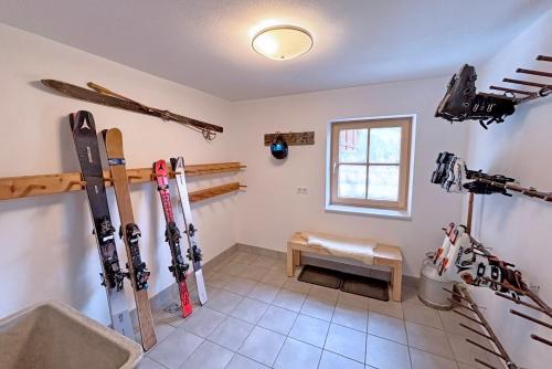 a room with skis and ski equipment on the wall at Apartments Frechhof in Schladming