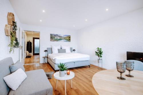 a bedroom with a bed and a living room at Jopachalets Pfronten in Pfronten
