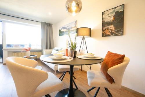 a living room with a table and chairs at Jopachalets Pfronten in Pfronten