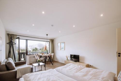 a bedroom with a bed and a living room at Jopachalets Pfronten in Pfronten
