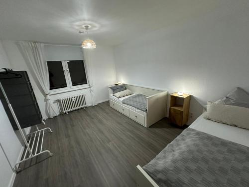 a bedroom with two beds and a tv in it at Little Royal in Garbsen