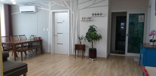 a living room with a table and a dining room at Mr. Kim Guesthouse in Incheon