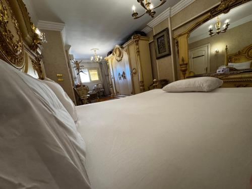 a bedroom with a large white bed in a room at center of Alexandria in Alexandria