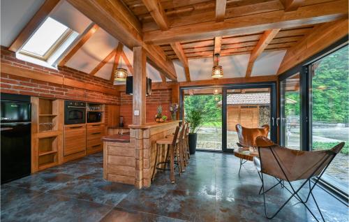 a kitchen with a bar and a table and chairs at Cozy Home In Vitesinec With Sauna in Salinovec