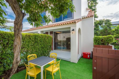 a table and chairs in the yard of a house at Venice Beach Village Hua Hin Pool Villa in Cha Am