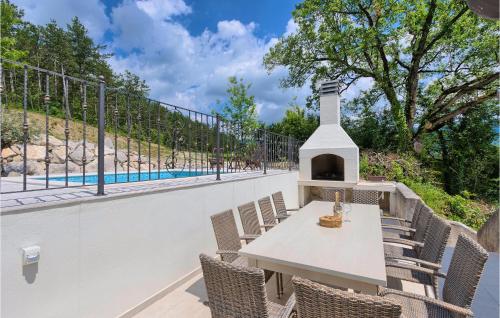 a patio with a table and chairs and a pool at Gorgeous Home In Buzet in Buzet
