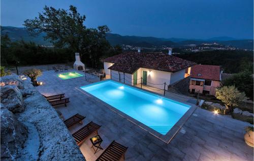 a villa with a swimming pool at night at Gorgeous Home In Buzet in Buzet