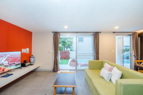 a living room with a couch and a table at Venice Beach Village Hua Hin Pool Villa in Cha Am