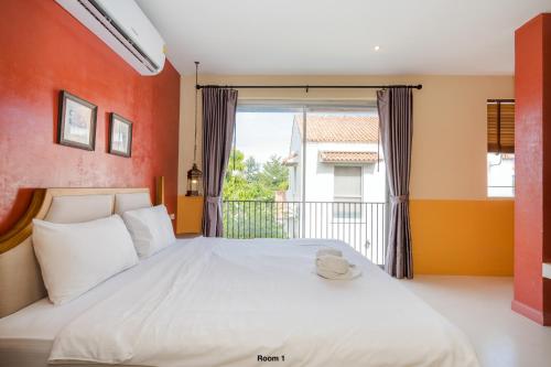 a bedroom with a large bed and a balcony at Venice Beach Village Hua Hin Pool Villa in Cha Am