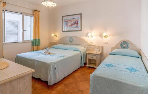 a bedroom with two beds and a window at Bilo 5 in Orosei