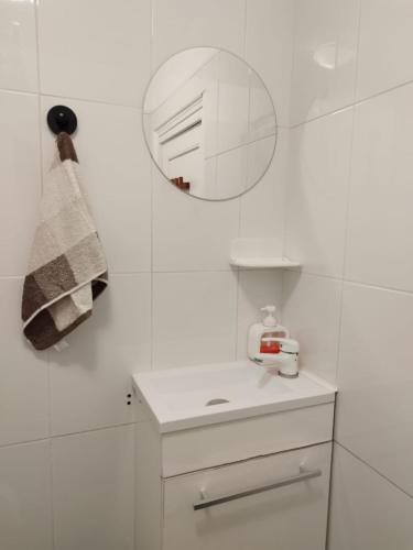 une salle de bain blanche avec un lavabo et un miroir dans l'établissement Private Room in Shared Apartment in the Center of Nice, à Nice