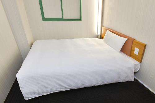 a small bedroom with a white bed in it at R&B Hotel Kumamoto Shimotori - Vacation STAY 39079v in Kumamoto