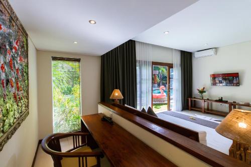 a bedroom with a large bed and a large window at Delight ART Villas in Seminyak