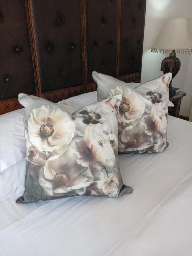 three pillows on top of a bed at Lamon Guesthouse in Kroonstad