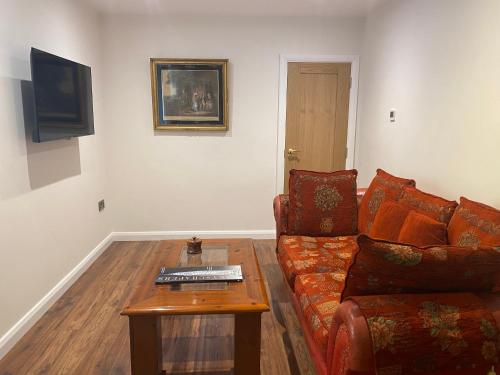 a living room with a couch and a coffee table at The Cottage, Walworth Demesne in Ballykelly